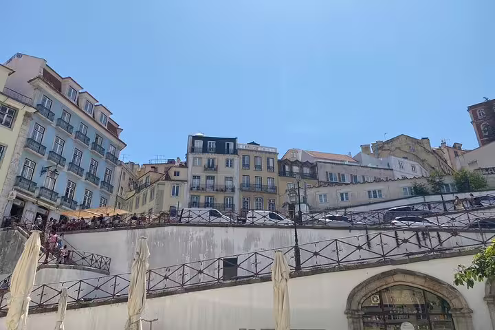 Discover Lisbon's charming hillside neighborhoods with colorful facades and vibrant street cafes on a full-day tour.