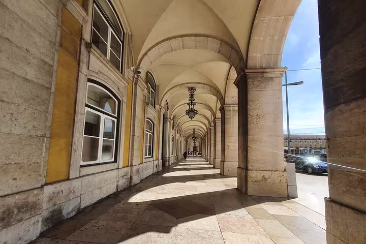 Stunning arched walkway in Lisbon's historic district, showcasing classic architecture on the Old Town, New Town & Belem tour.