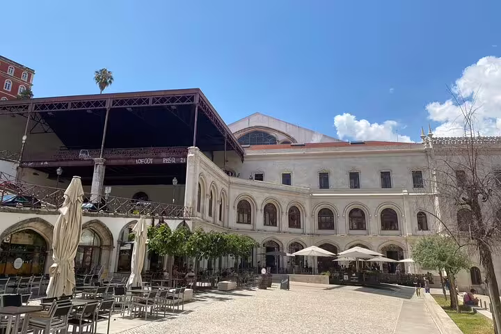 Explore Lisbon's historic architecture with open-air cafes and elegant arches on a private full-day tour.