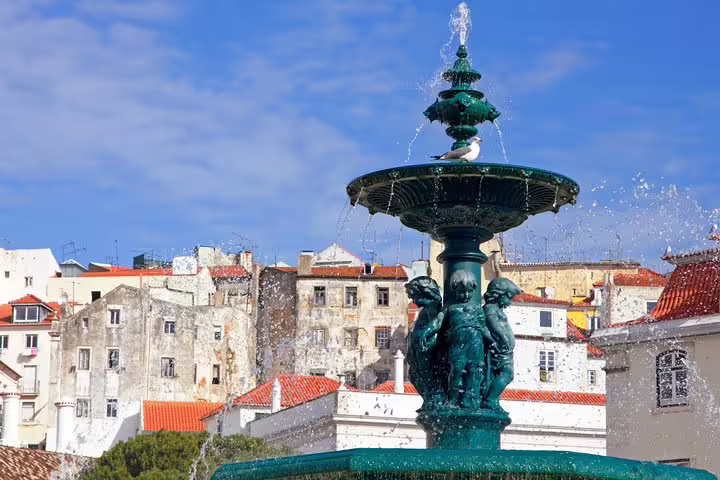Historic Lisbon fountain with intricate sculptures and vibrant architecture, featured in a premium full-day private tour.