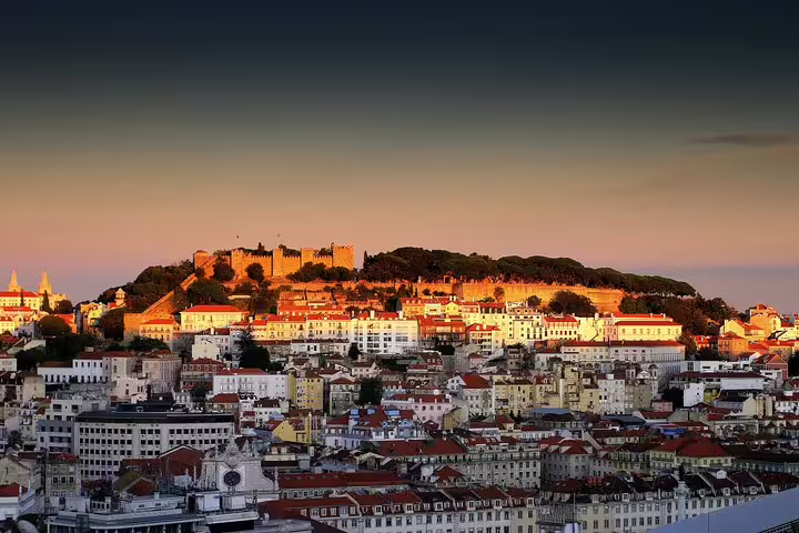 Scenic view of Lisbon's historic skyline with São Jorge Castle at sunset, perfect for a Jewish heritage private full-day tour.