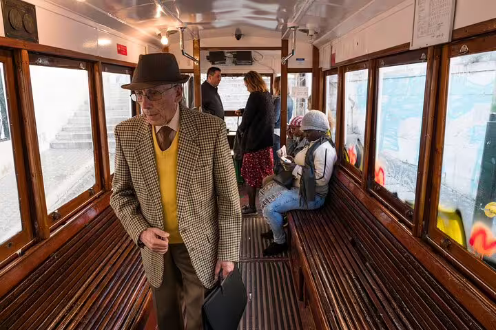 Inside a classic Lisbon tram, locals and tourists enjoy an authentic cultural experience off the typical tourist path.