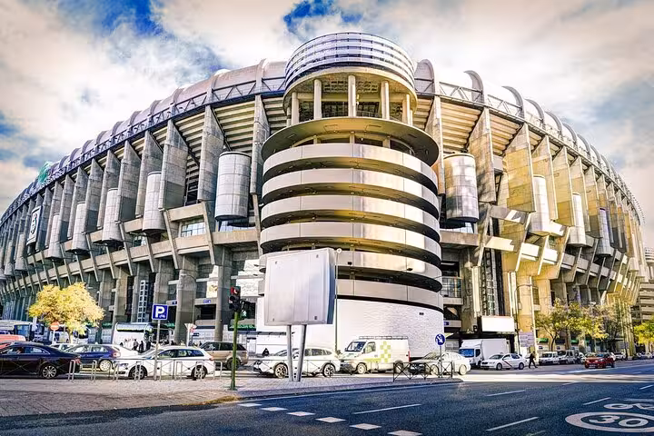 Iconic stadium in Madrid featuring modern architecture and bustling surroundings, part of Lisbon to Madrid luxury transfer.