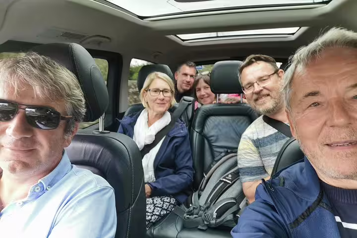 Group enjoying Lisbon to Madrid private transfer with scenic stops in Evora and Toledo, highlighting comfort and adventure.