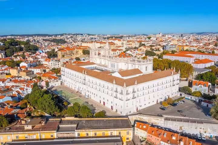 Aerial view of Lisbon's Monastery of São Vicente de Fora, surrounded by traditional Portuguese architecture.