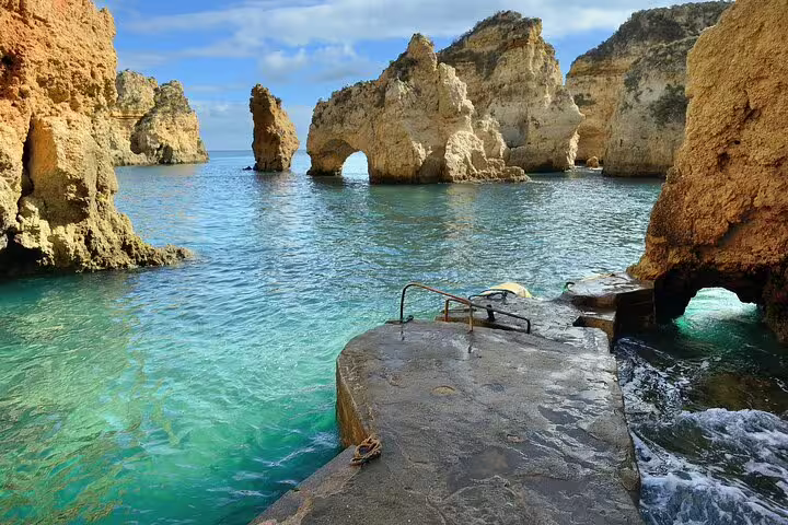 Scenic view of rock formations and turquoise waters at Ponta da Piedade, Lagos, Portugal, ideal for Lisbon to Nazaré tours.