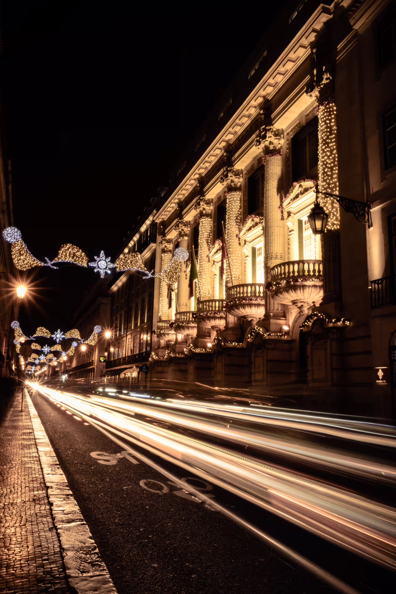 Vibrant Lisbon street adorned with enchanting Christmas lights, capturing the festive spirit on a private night photo walk.