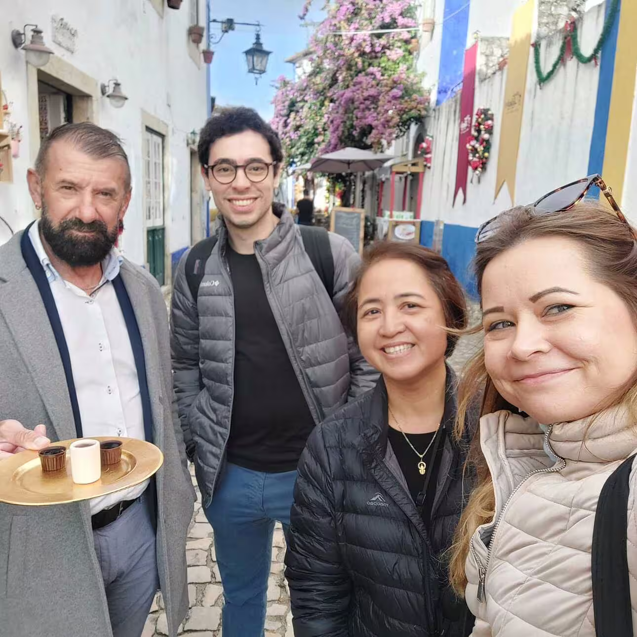 Tourists enjoying a guided walk through the charming streets of Óbidos, part of the Lisbon guided tour to Fátima, Nazaré, Batalha.