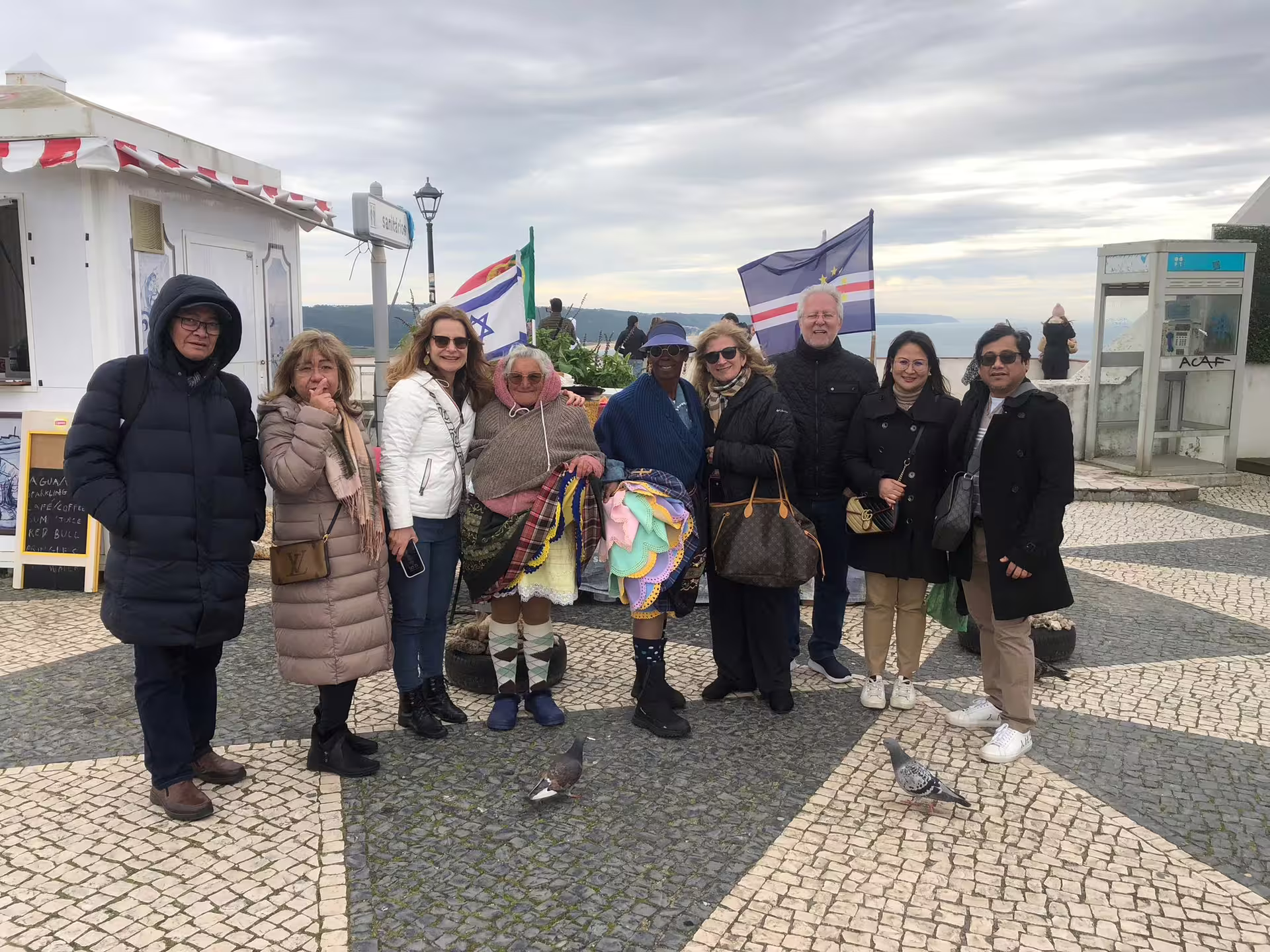 Join a diverse group of travelers in Óbidos, enjoying local culture and picturesque views on the Lisbon-guided tour.