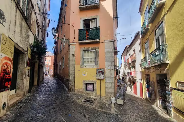 Colorful narrow streets of Lisbon's Old Town with traditional architecture, perfect for exploring on a small-group tour.