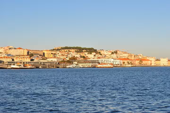 Lisbon old town waterfront skyline from the Tagus River on a 2-hour small group sailing cruise with drink included