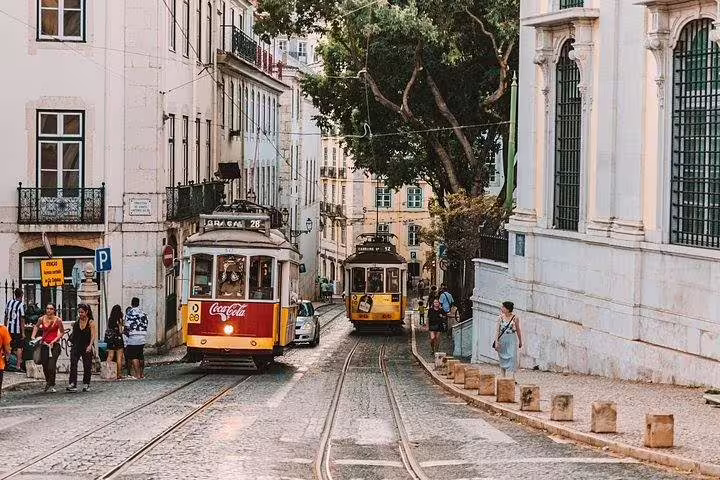 Iconic trams in Lisbon's charming old town, showcasing the city's historic charm and vibrant street life.