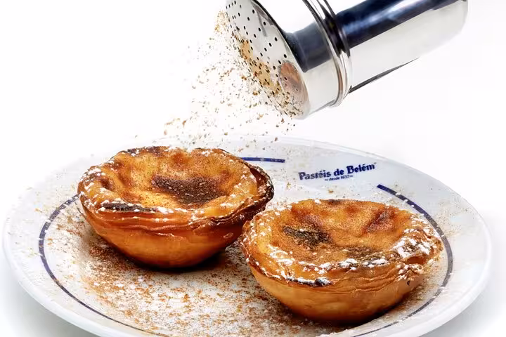 Savor authentic Pastéis de Belém dusted with cinnamon, a highlight of your full-day private Lisbon tour.