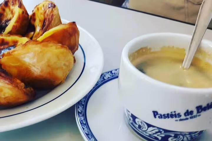 Delight in Lisbon's iconic Pastéis de Belém with coffee during a premium private tour, featuring custom stops and luxury travel.