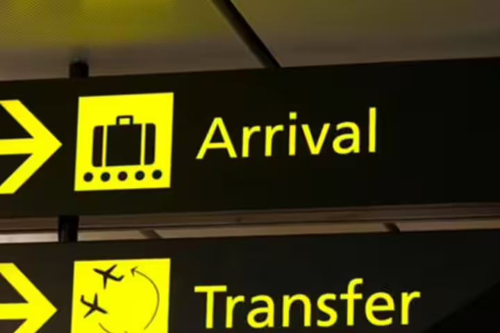 Airport arrival and transfer signs directing travelers, ideal for Lisbon to Porto or Algarve private transfer services.