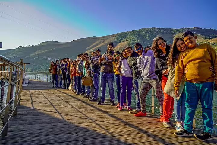 Group enjoying a Douro River boardwalk viewpoint, highlight of a 2-day private tour from Lisbon to Porto & Douro