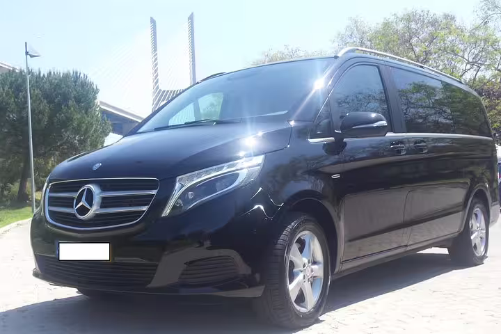 Luxurious black Mercedes van for private Lisbon to Porto journey, offering direct routes or personalized stops along scenic Portugal.