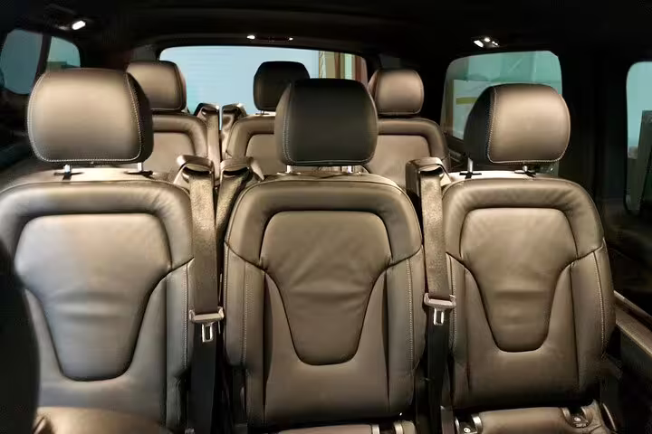 Luxurious leather interior of a spacious van for Lisbon to Porto private journey with options for direct route or customized stops.