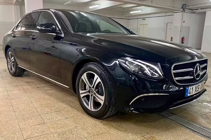 Luxury black Mercedes-Benz sedan for Lisbon to Porto private journey with customizable stops, offering comfort and style.