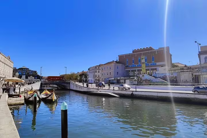 Scenic view of the charming canal and colorful buildings in Aveiro, Portugal, a highlight on the Lisbon to Porto private transfer.