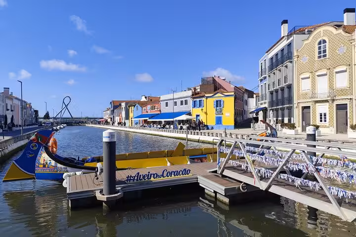 Aveiro canal with traditional moliceiro boat, scenic stop on Lisbon to Porto private transfer tour