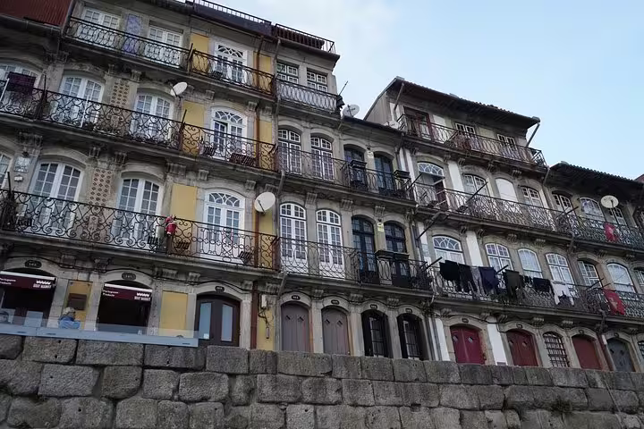 Historic Portuguese architecture in Porto showcases colorful facades and intricate balconies, perfect for Lisbon to Porto tours.