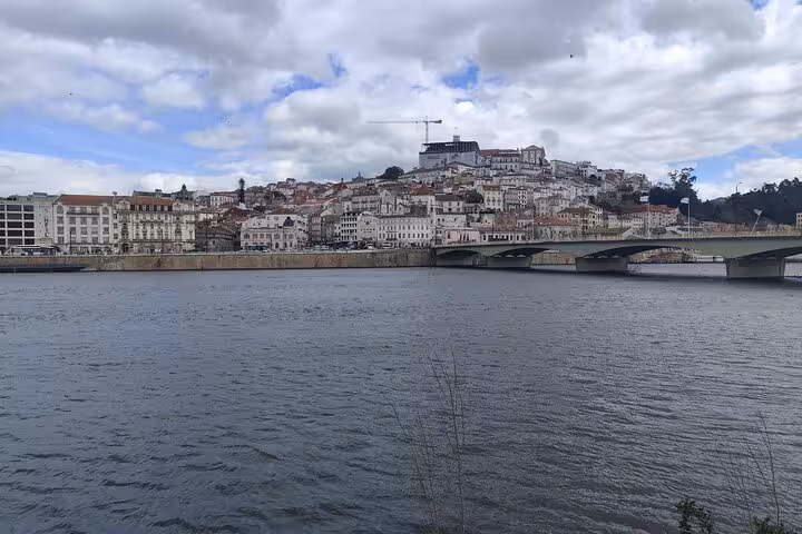 Scenic riverfront cityscape on Lisbon to Porto transfer, bridge and hillside skyline along the route