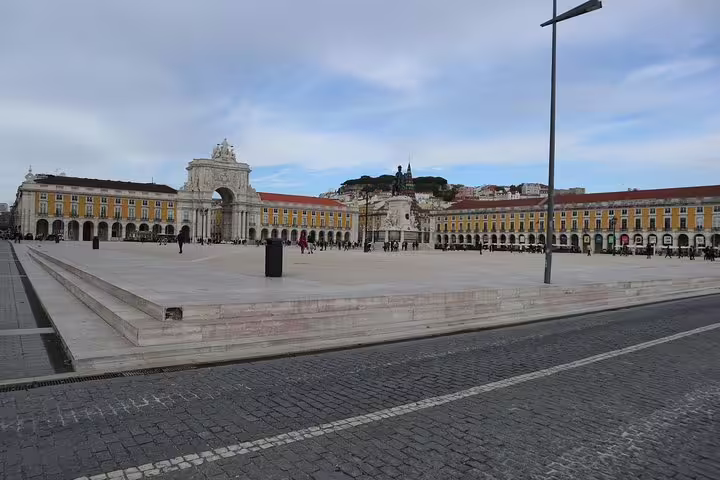 Vibrant Praça do Comércio in Lisbon, featuring grand architecture and a bustling atmosphere on the city tour.