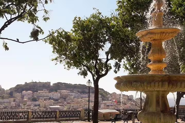 Fountain view from a scenic lookout in Lisbon, highlighting the charm of a half-day private tour with custom stops and premium vehicle.
