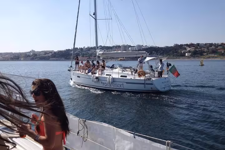 Lisbon waterfront skyline on the Tagus River during a private sailing cruise with drink included