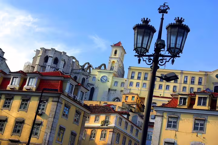 Scenic view of Lisbon's historic architecture with colorful buildings and iconic clock tower, featured in a premium private tour.