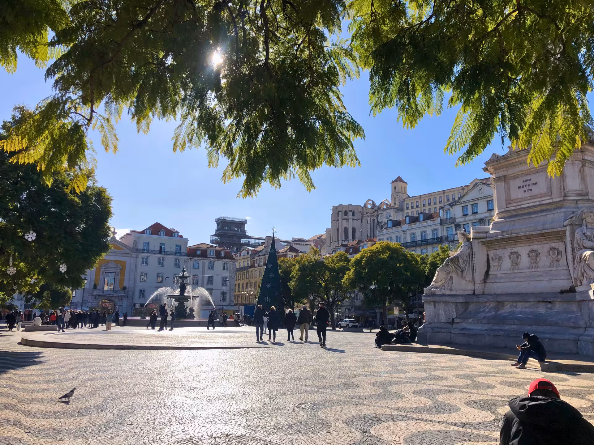 Lisbon Rossio Square view with fountain and historic façades, a stop on the Old Shops, Traditions & Stories tour