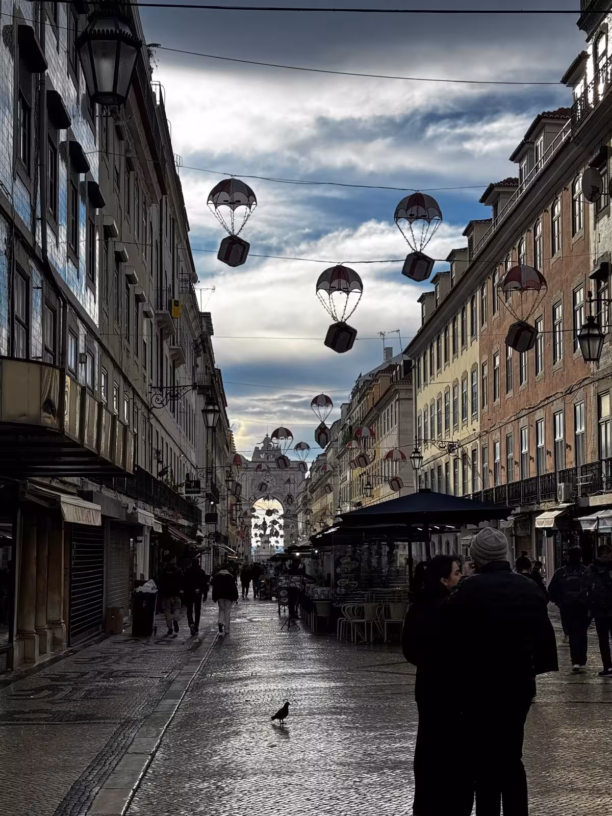 Rua Augusta in downtown Lisbon with hanging parachute lights and Arco da Rua Augusta, ideal for audio guided City Quest