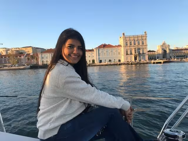 Guest relaxing on a Lisbon sailing boat with waterfront skyline views, Cultural Sail Tour Lisbon experience