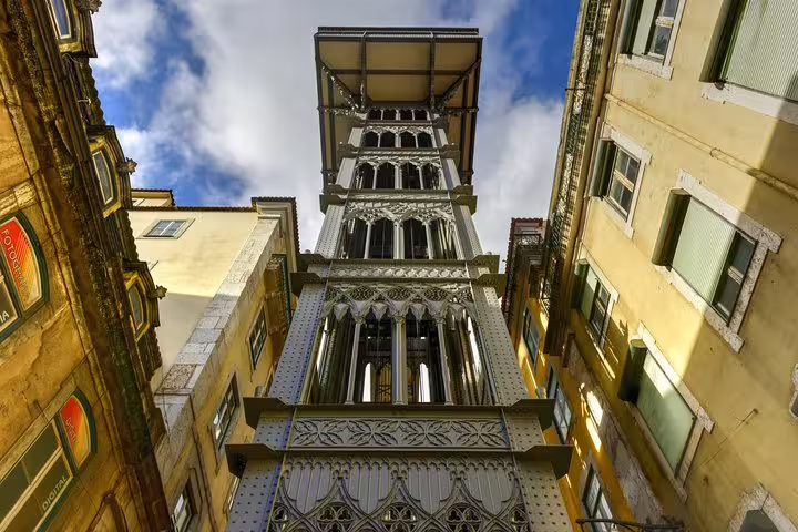 View of the iconic Santa Justa Lift in Lisbon on a sunny day, showcasing its intricate architecture and historical significance.