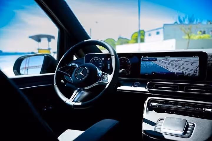 Interior view of a Mercedes with modern dashboard and navigation system for Lisbon to Seville transfer.