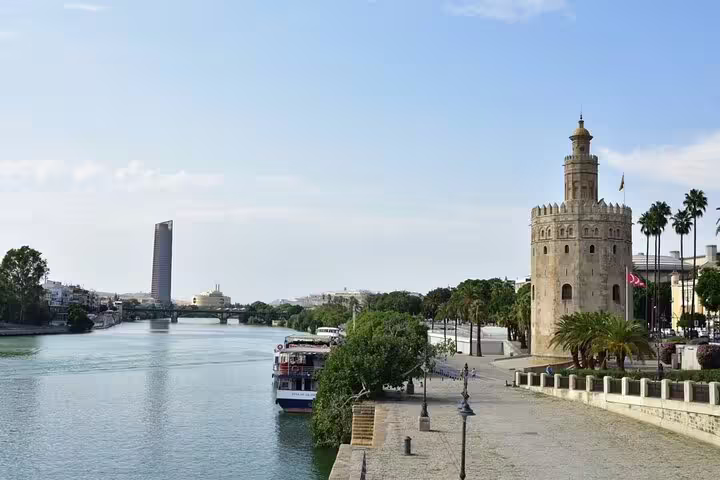 View of Seville's Torre del Oro along the Guadalquivir River, a highlight on the Lisbon to Seville Private Journey.