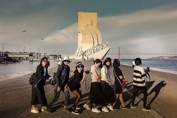 Tourists enjoy a sunny day at the Monument to the Discoveries in Lisbon during a private tour of Lisbon, Sintra, Roca, and Cascais.