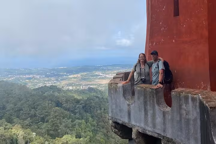 Couple enjoying panoramic views from the scenic terraces of Pena Palace during a guided tour from Lisbon to Sintra.