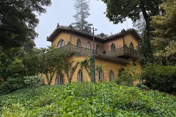 Quaint chalet surrounded by lush greenery in Sintra, a picturesque stop on the Lisbon to Sintra guided tour.