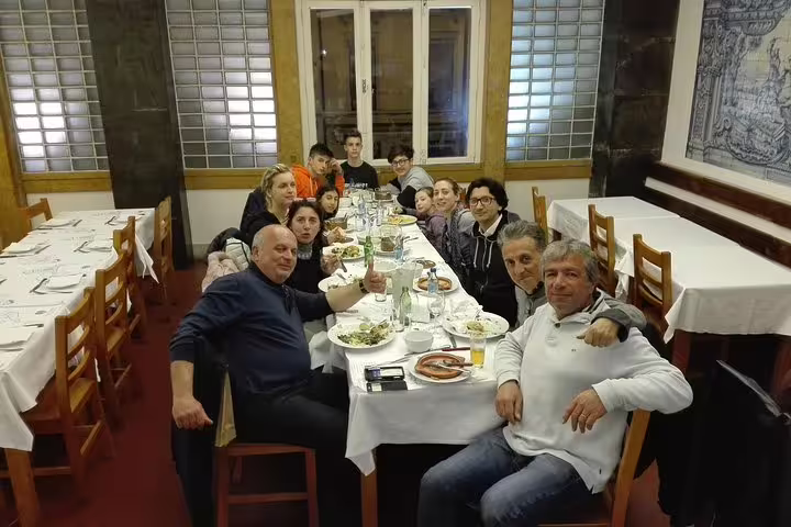 Group enjoying a traditional Portuguese meal during a 2-day private tour in Lisbon, Sintra, Roca, and Cascais.