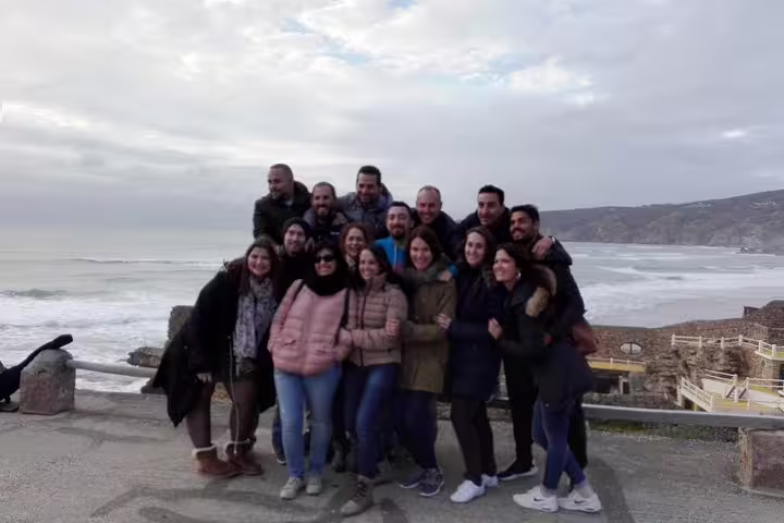 Group of tourists enjoying a scenic view of the Atlantic Ocean during a private tour of Lisbon, Sintra, Roca, and Cascais.