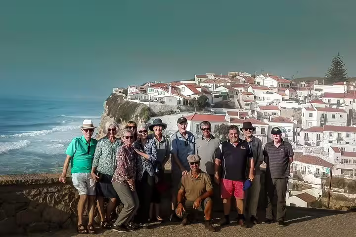 Group enjoying stunning coastal views on a private 2-day tour of Lisbon, Sintra, Roca, and Cascais with charming village backdrop.