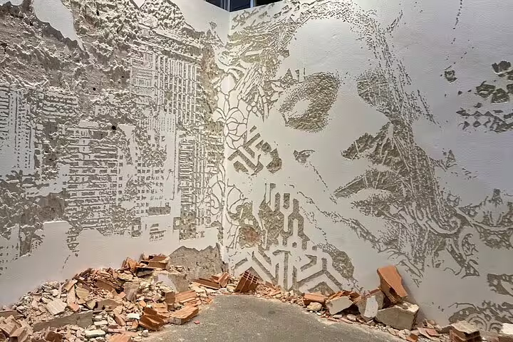 Intricate Lisbon street art mural depicting a face and urban motifs, showcasing the city's vibrant cultural scene.