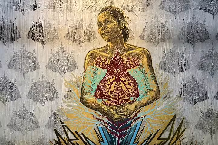 Colorful Lisbon street art featuring a woman with nature motifs, capturing the city's dynamic and diverse artistic expression.