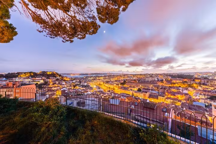 Breathtaking sunset view over Lisbon skyline from a scenic overlook on a half-day private tour.