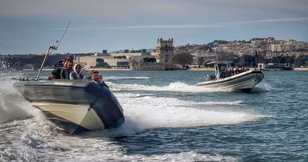 Lisbon sunset speedboat tour racing past Belém Tower on the Tagus River with thrilling wake and skyline views
