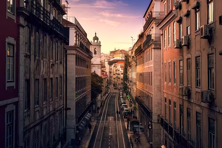Charming Lisbon street view at sunset, ideal for exploring on the 7-day guided tour from Madrid to Portugal.