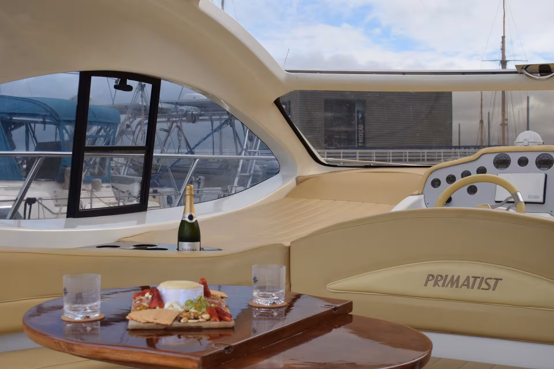 Private yacht deck table with champagne and snacks at Lisbon marina, A Lisbon Tale by On Tales boat experience.