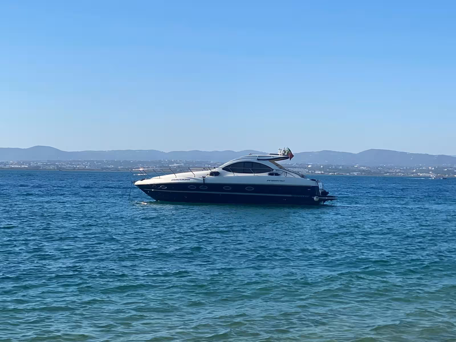 Private yacht cruising on the Tagus River in Lisbon, scenic waterfront views for A Lisbon Tale by On Tales